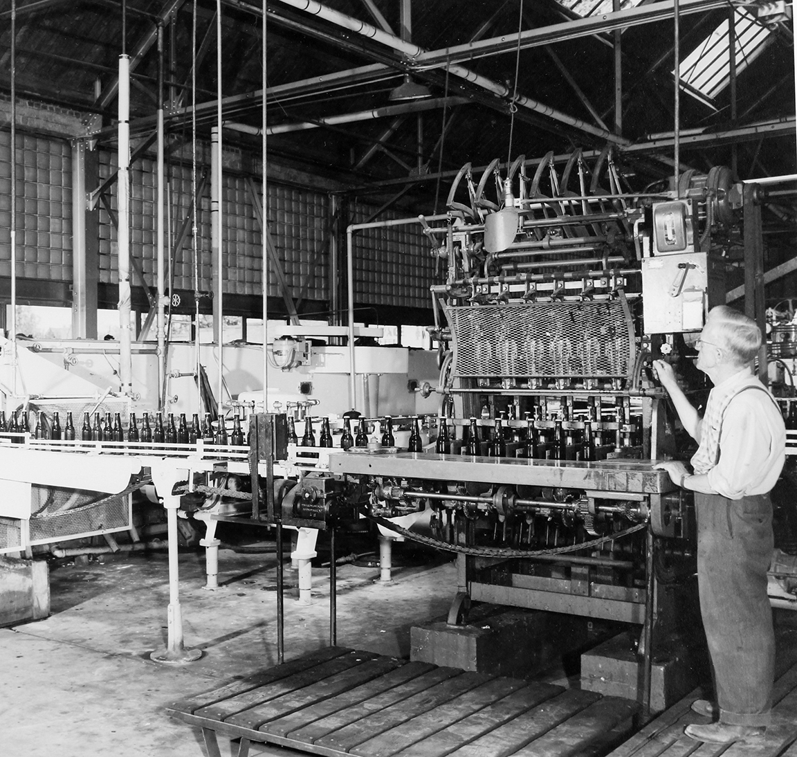 Carl Burbott manning bottling machine